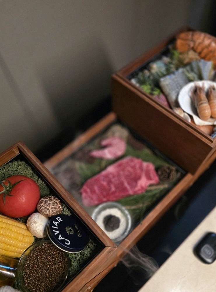 WOOARA Yeouido · the signature Hanwoo showing — marbled beef cuts and caviar presented in a display chest
