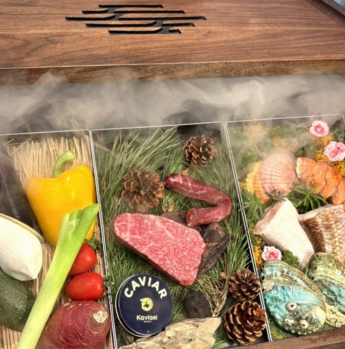 WOOHANA Yeouido · the signature Hanwoo showing — marbled beef cuts and caviar presented in a display chest