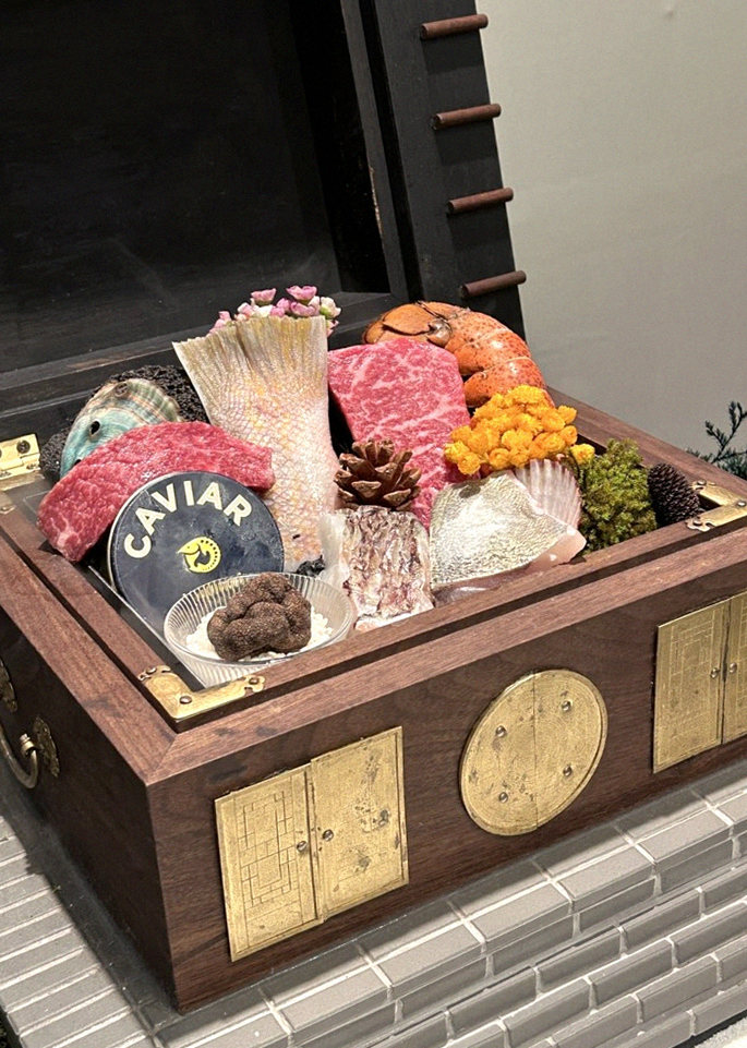 GOWOOGA Yeouido · the signature Hanwoo showing — marbled beef cuts and caviar presented in a display chest