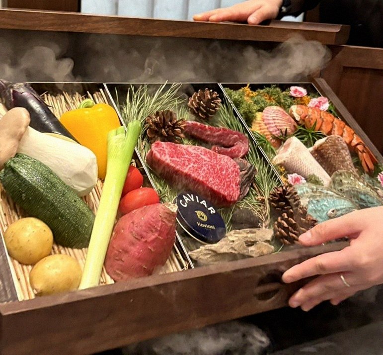WOOHANA Jonggak · the signature Hanwoo showing — marbled beef cuts and caviar presented in a display chest