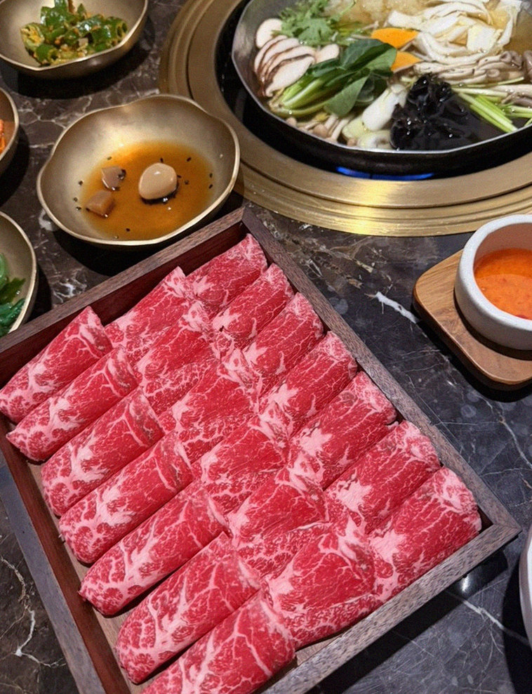 DAEBOJUNG City Hall · the signature Hanwoo showing — marbled beef cuts and caviar presented in a display chest