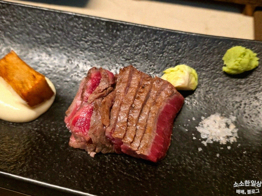 WOOARA Yeouido · the signature Hanwoo showing — marbled beef cuts and caviar presented in a display chest
