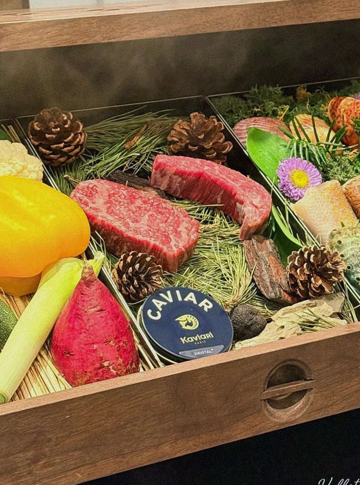 WOOHANA Yeouido · the signature Hanwoo showing — marbled beef cuts and caviar presented in a display chest