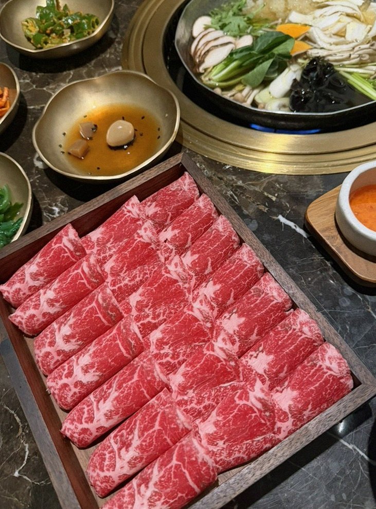 DAEBOJUNG City Hall · the signature Hanwoo showing — marbled beef cuts and caviar presented in a display chest