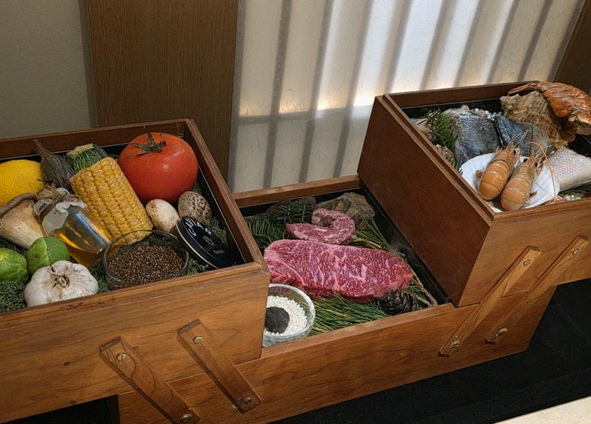 WOOARA Yeouido · the signature Hanwoo showing — marbled beef cuts and caviar presented in a display chest