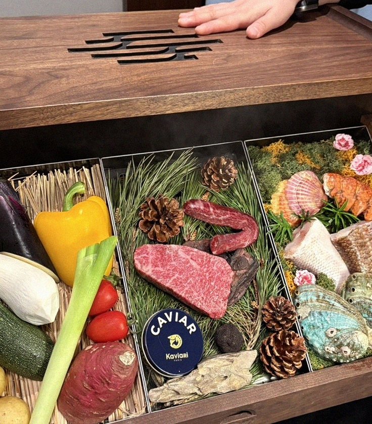 WOOHANA Yeouido · the signature Hanwoo showing — marbled beef cuts and caviar presented in a display chest