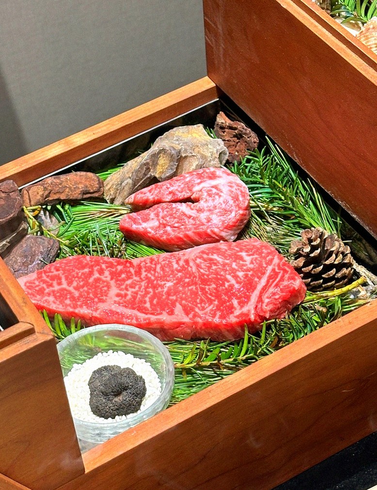 WOOARA Yeouido · the signature Hanwoo showing — marbled beef cuts and caviar presented in a display chest