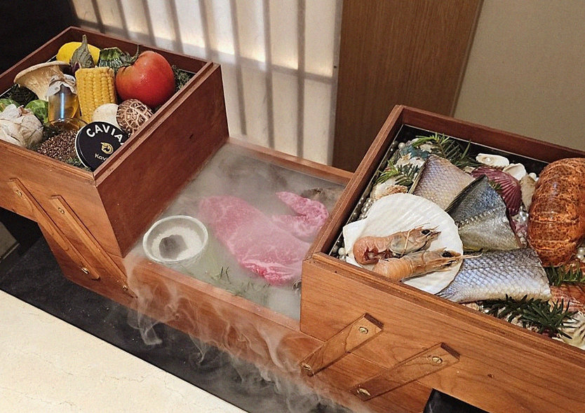 WOOARA Yeouido · the signature Hanwoo showing — marbled beef cuts and caviar presented in a display chest