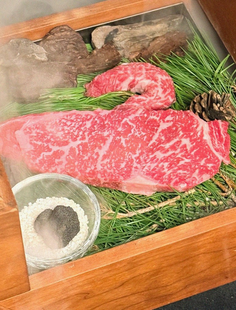 WOOARA Yeouido · the signature Hanwoo showing — marbled beef cuts and caviar presented in a display chest