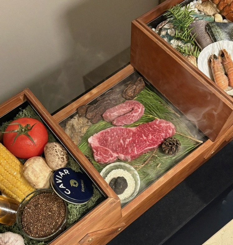 WOOARA Gwanghwamun · the signature Hanwoo showing — marbled beef cuts and caviar presented in a display chest