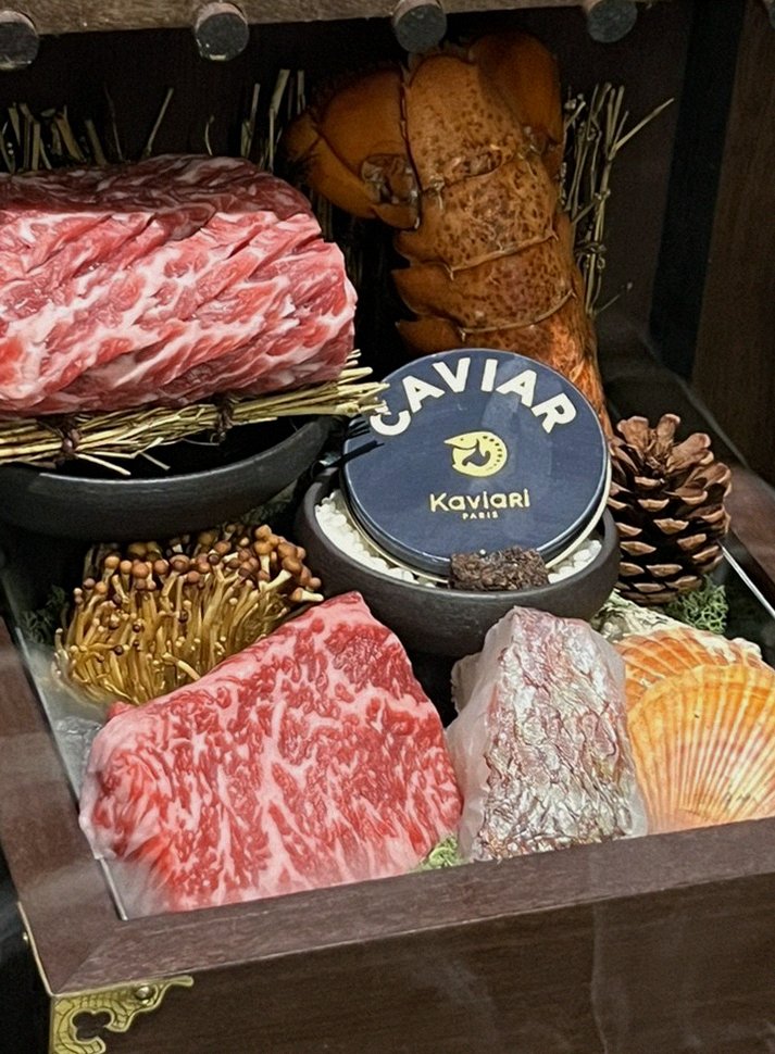DAEBOJUNG Yeouido · the signature Hanwoo showing — marbled beef cuts and caviar presented in a display chest