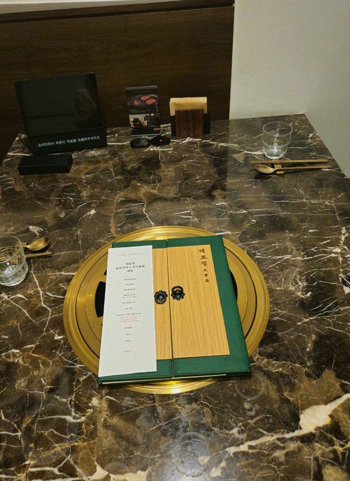 DAEBOJUNG City Hall · the signature Hanwoo showing — marbled beef cuts and caviar presented in a display chest