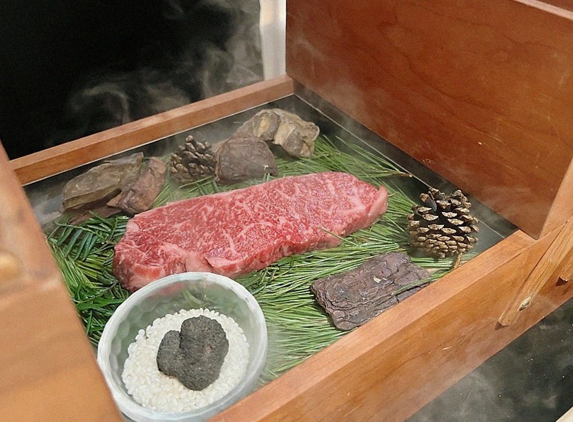 WOOARA Yeouido · the signature Hanwoo showing — marbled beef cuts and caviar presented in a display chest