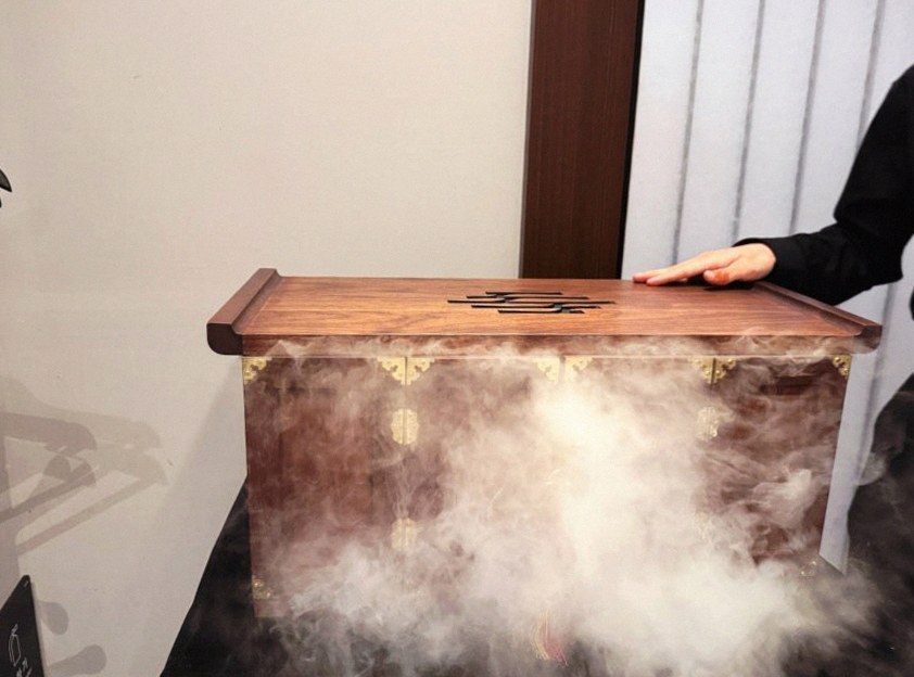 WOOHANA Jonggak · the signature Hanwoo showing — marbled beef cuts and caviar presented in a display chest