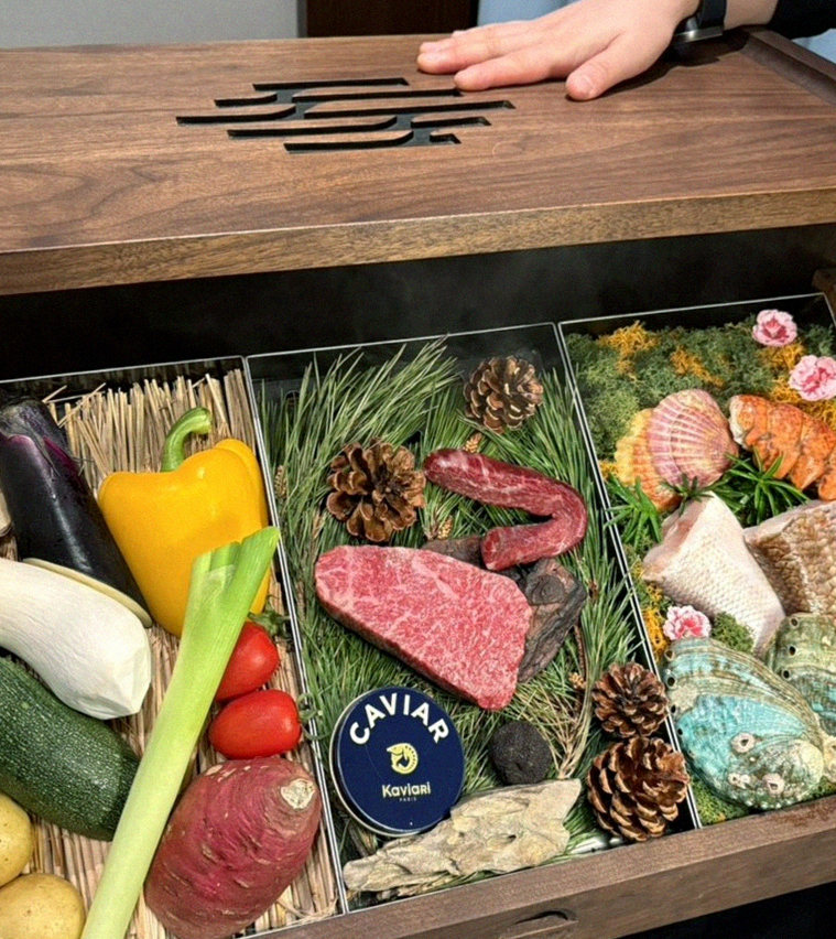 WOOHANA Jonggak · the signature Hanwoo showing — marbled beef cuts and caviar presented in a display chest