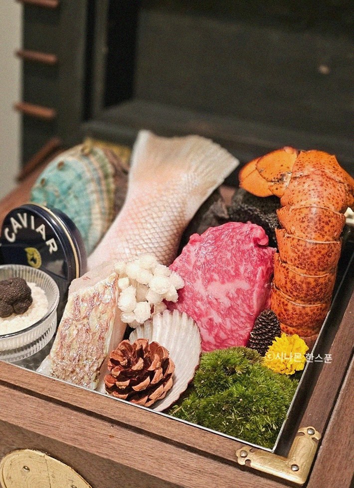 GOWOOGA Gangnam·Yeoksam · the signature Hanwoo showing — marbled beef cuts and caviar presented in a display chest