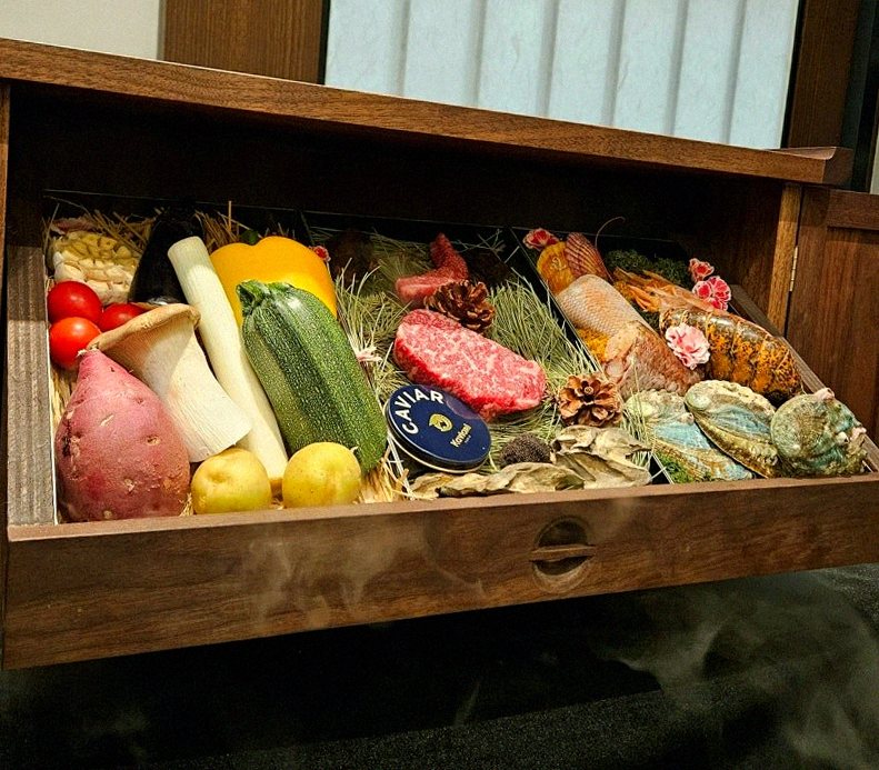 WOOHANA Jonggak · the signature Hanwoo showing — marbled beef cuts and caviar presented in a display chest