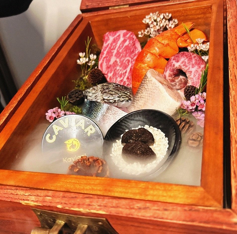 GOWOOGA Yeouido · the signature Hanwoo showing — marbled beef cuts and caviar presented in a display chest