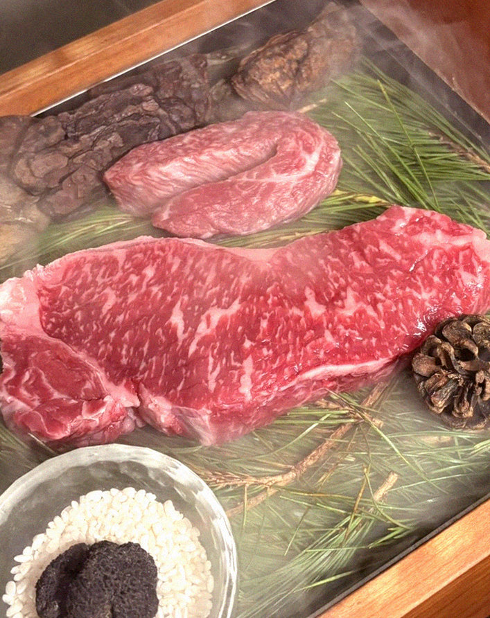 WOOARA Yeouido · the signature Hanwoo showing — marbled beef cuts and caviar presented in a display chest