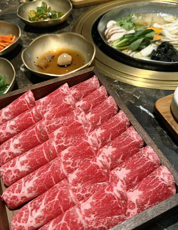 DAEBOJUNG City Hall · the signature Hanwoo showing — marbled beef cuts and caviar presented in a display chest