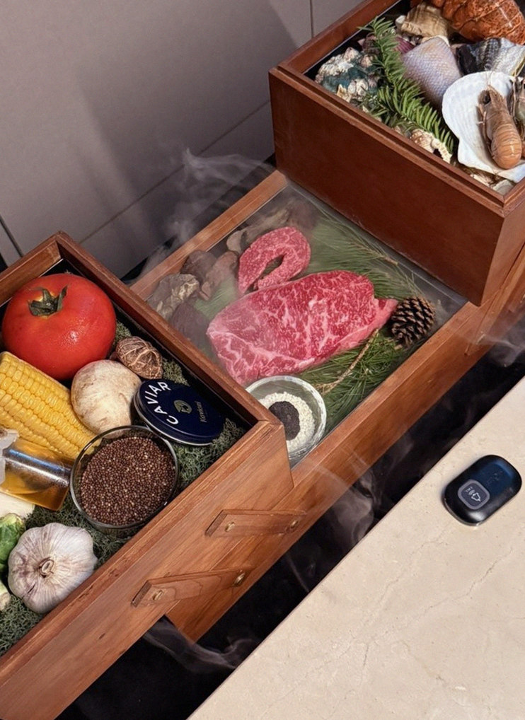 WOOARA Gwanghwamun · the signature Hanwoo showing — marbled beef cuts and caviar presented in a display chest