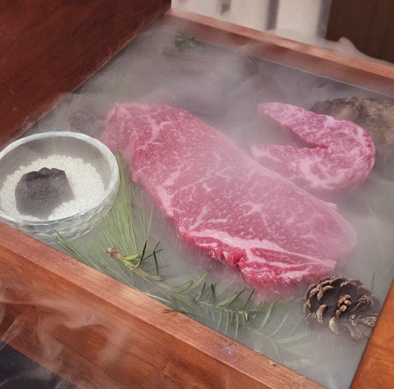 WOOARA Gwanghwamun · the signature Hanwoo showing — marbled beef cuts and caviar presented in a display chest