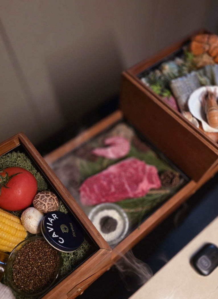 WOOARA Gwanghwamun · the signature Hanwoo showing — marbled beef cuts and caviar presented in a display chest