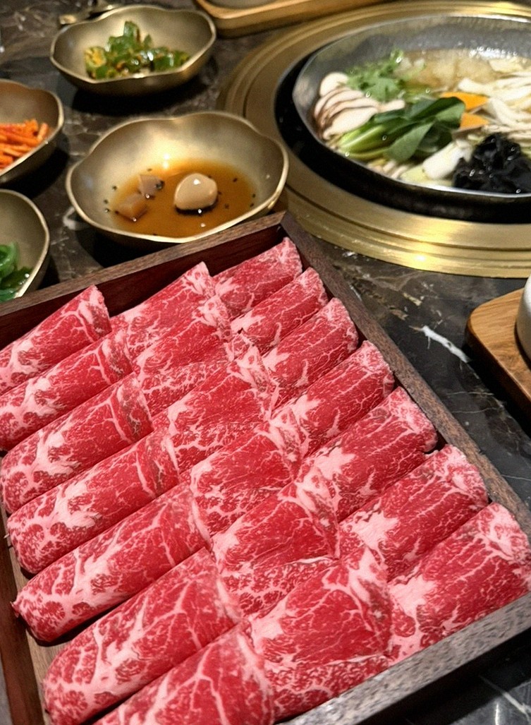 DAEBOJUNG City Hall · the signature Hanwoo showing — marbled beef cuts and caviar presented in a display chest