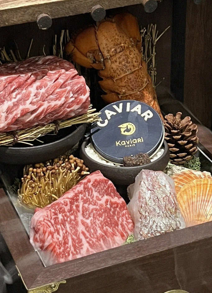 DAEBOJUNG Yeouido · the signature Hanwoo showing — marbled beef cuts and caviar presented in a display chest
