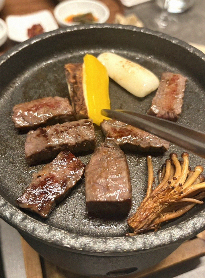 GOWOOGA Yeouido · the signature Hanwoo showing — marbled beef cuts and caviar presented in a display chest