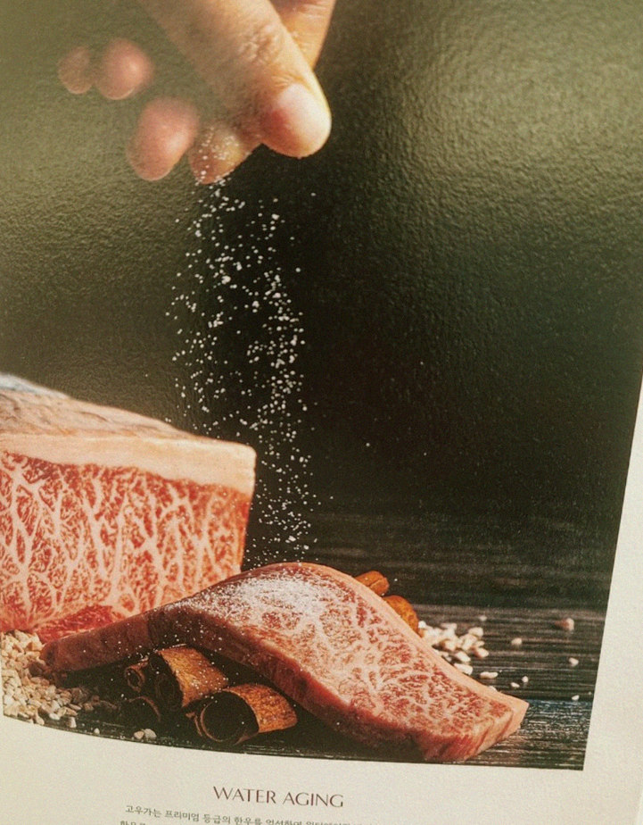 GOWOOGA Gwanghwamun · the signature Hanwoo showing — marbled beef cuts and caviar presented in a display chest