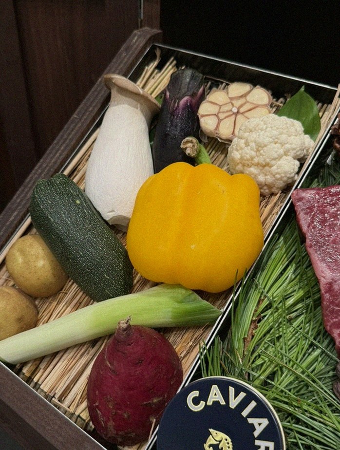 WOOHANA Yeouido · the signature Hanwoo showing — marbled beef cuts and caviar presented in a display chest