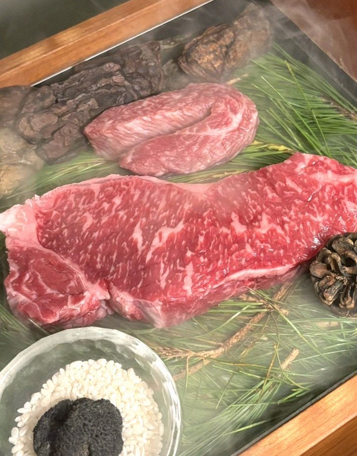 WOOARA Yeouido · the signature Hanwoo showing — marbled beef cuts and caviar presented in a display chest
