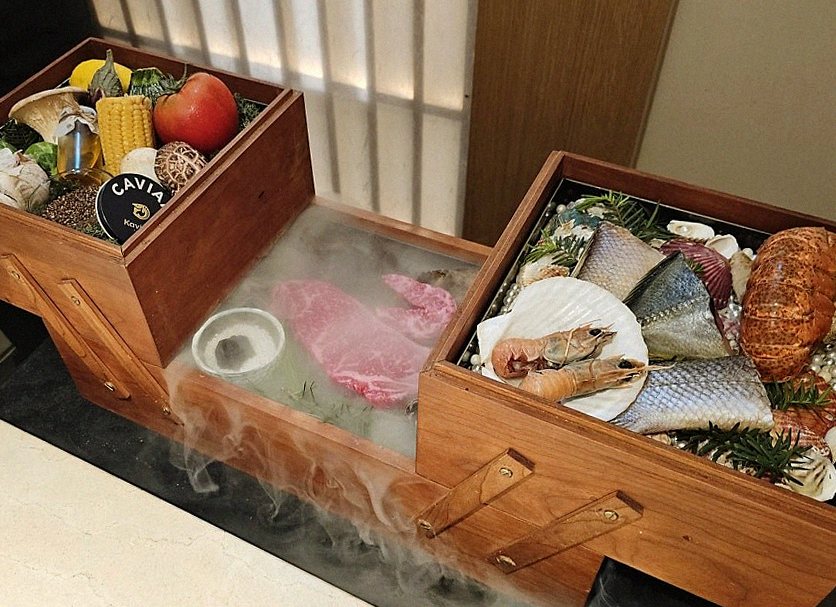 WOOARA Gwanghwamun · the signature Hanwoo showing — marbled beef cuts and caviar presented in a display chest