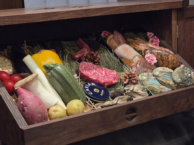 WOOHANA Yeouido · the signature Hanwoo showing — marbled beef cuts and caviar presented in a display chest