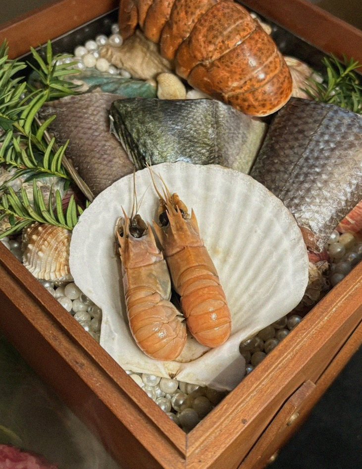WOOARA Yeouido · the signature Hanwoo showing — marbled beef cuts and caviar presented in a display chest