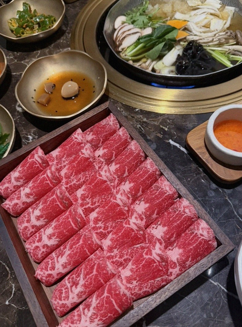 DAEBOJUNG Yeouido · the signature Hanwoo showing — marbled beef cuts and caviar presented in a display chest