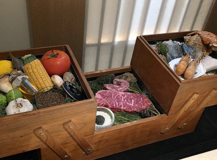WOOARA Yeouido · the signature Hanwoo showing — marbled beef cuts and caviar presented in a display chest
