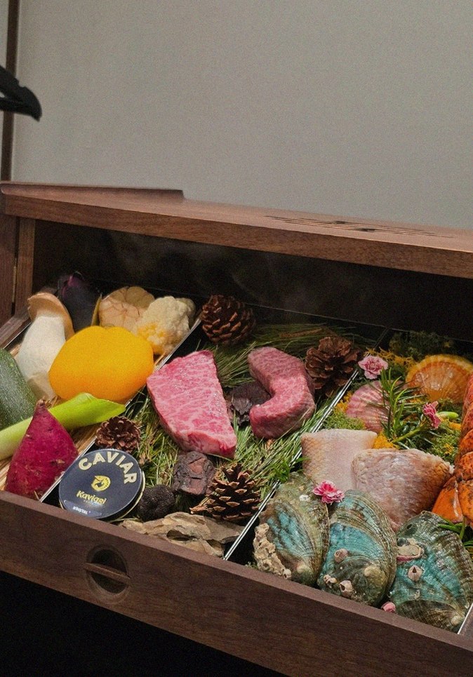 WOOHANA Jonggak · the signature Hanwoo showing — marbled beef cuts and caviar presented in a display chest