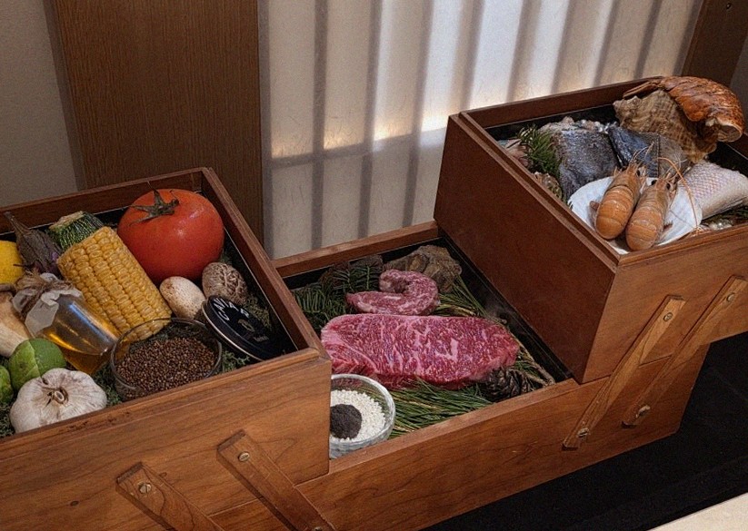 WOOARA Gwanghwamun · the signature Hanwoo showing — marbled beef cuts and caviar presented in a display chest