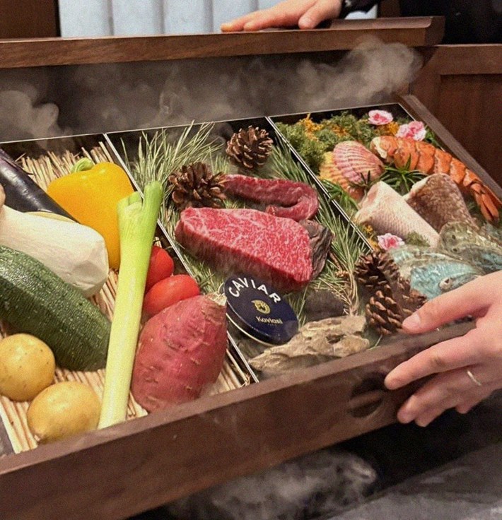 WOOHANA Yeouido · the signature Hanwoo showing — marbled beef cuts and caviar presented in a display chest