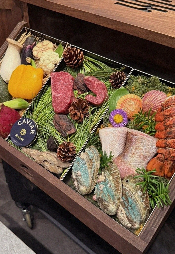 WOOHANA Yeouido · the signature Hanwoo showing — marbled beef cuts and caviar presented in a display chest