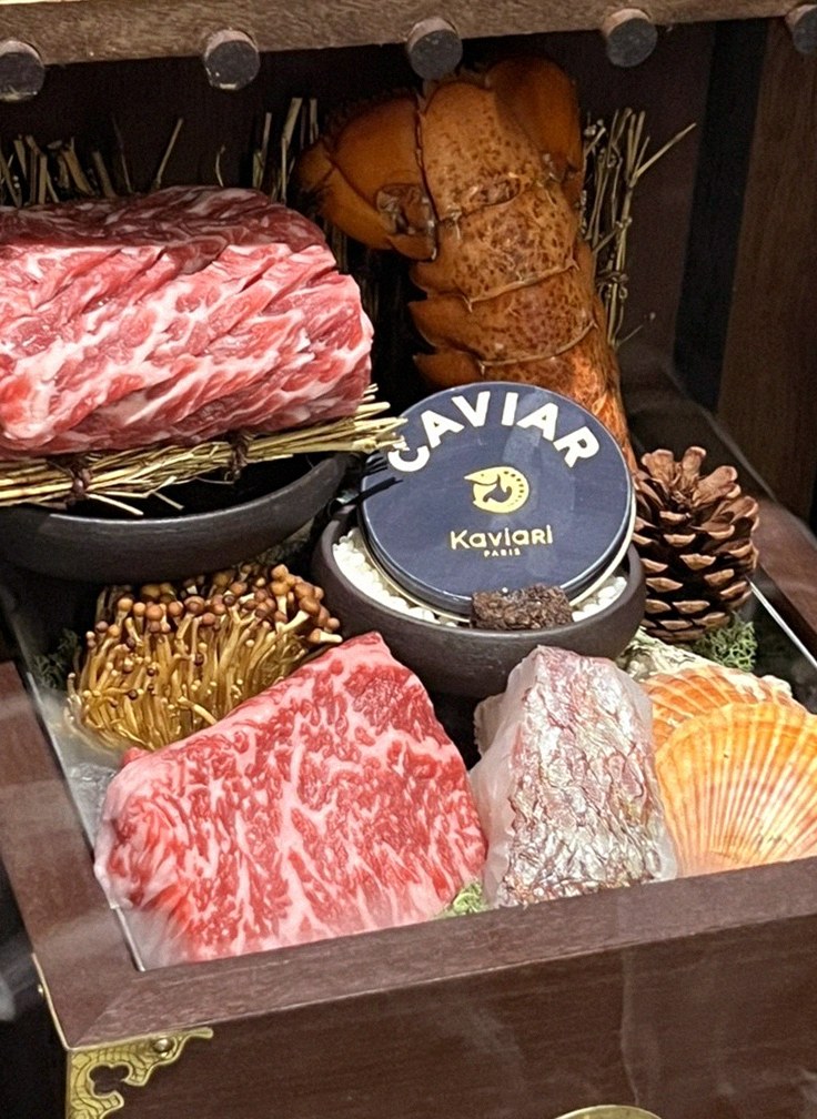 DAEBOJUNG City Hall · the signature Hanwoo showing — marbled beef cuts and caviar presented in a display chest