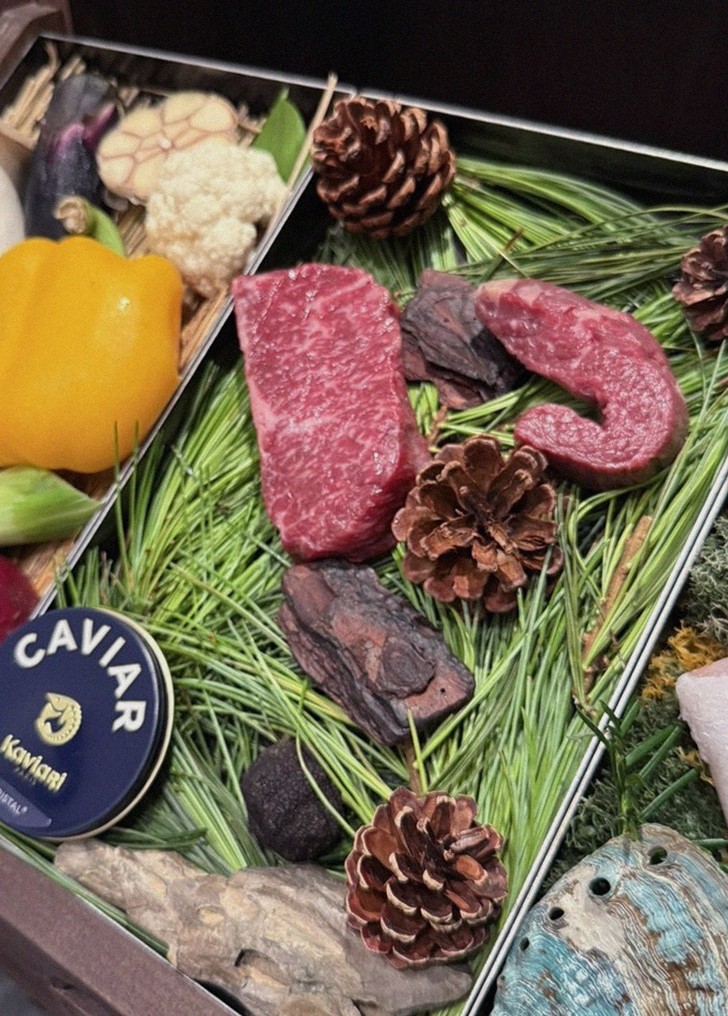 WOOHANA Jonggak · the signature Hanwoo showing — marbled beef cuts and caviar presented in a display chest