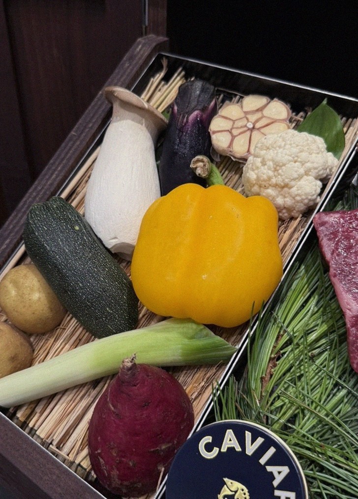WOOHANA Jonggak · the signature Hanwoo showing — marbled beef cuts and caviar presented in a display chest