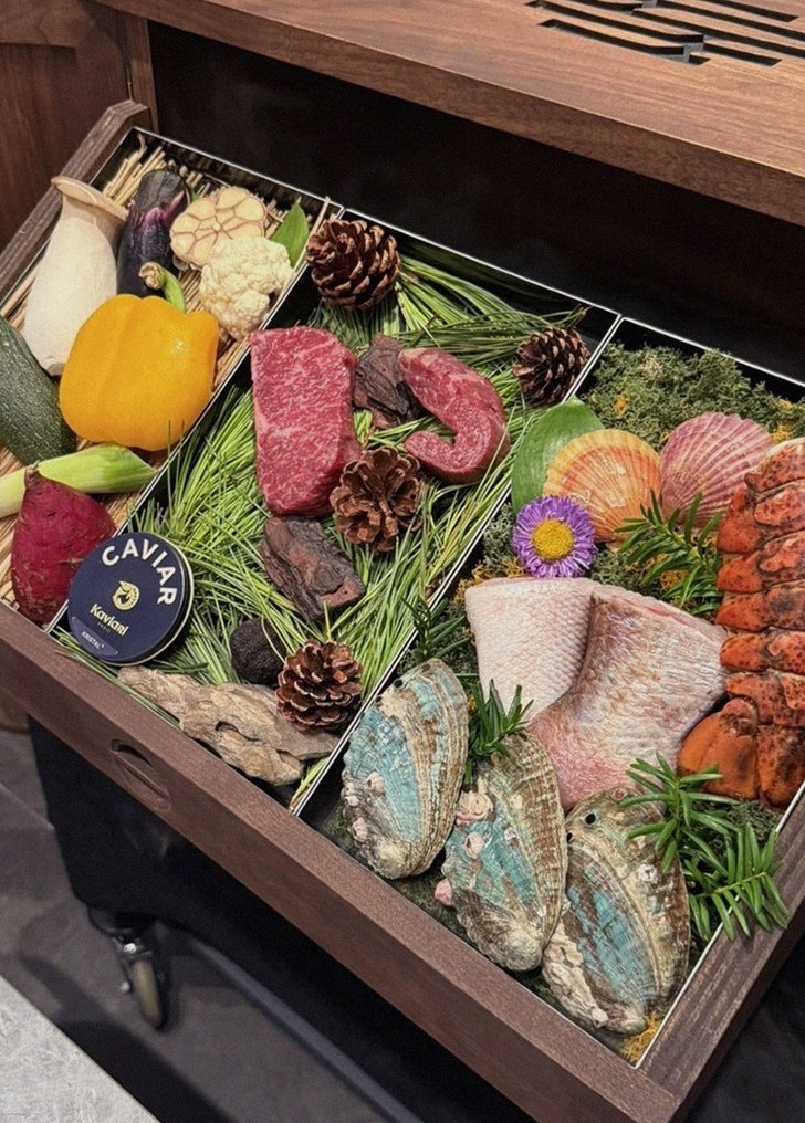 WOOHANA Jonggak · the signature Hanwoo showing — marbled beef cuts and caviar presented in a display chest