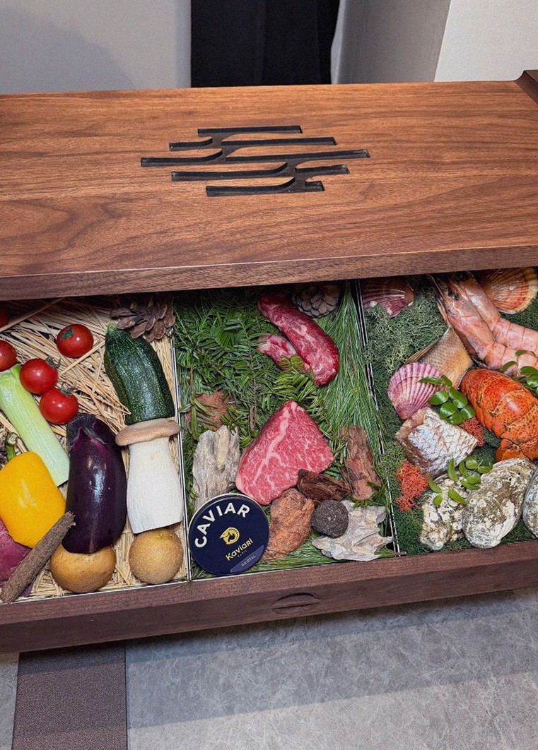 WOOHANA Jonggak · the signature Hanwoo showing — marbled beef cuts and caviar presented in a display chest