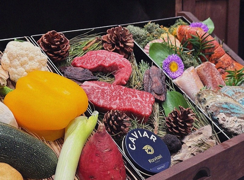 WOOHANA Jonggak · the signature Hanwoo showing — marbled beef cuts and caviar presented in a display chest