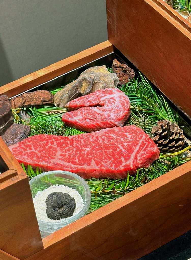 WOOARA Yeouido · the signature Hanwoo showing — marbled beef cuts and caviar presented in a display chest