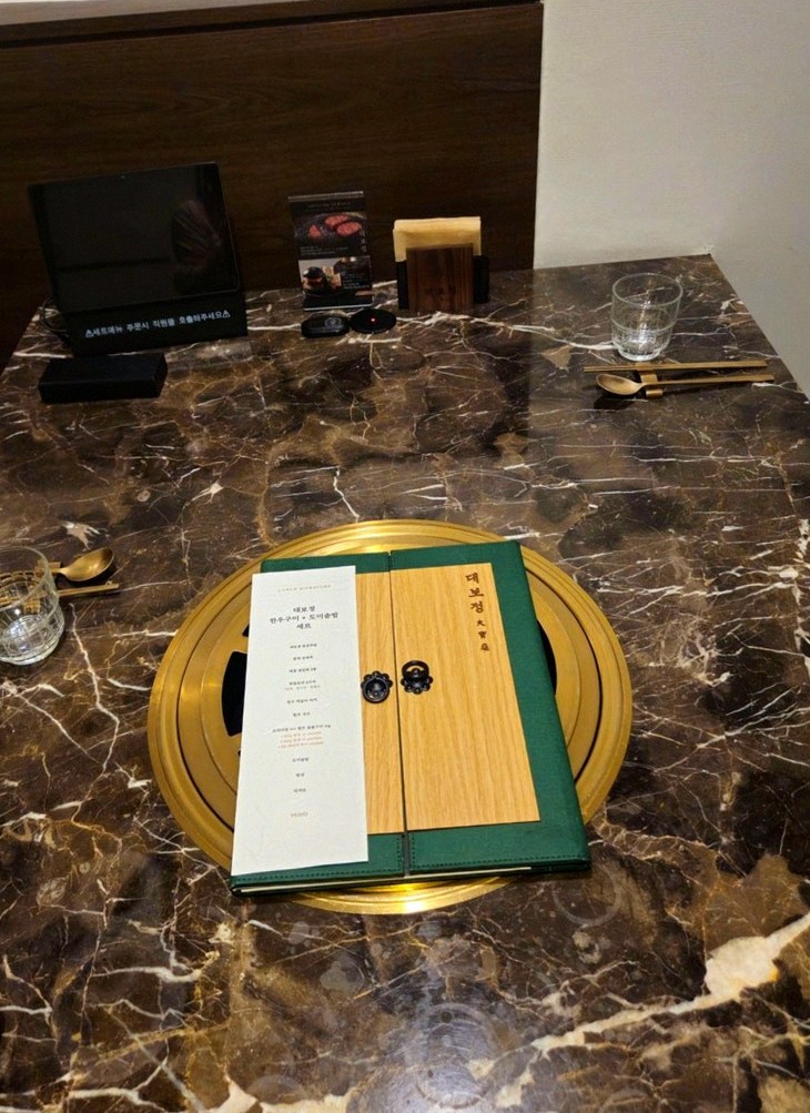 DAEBOJUNG City Hall · the signature Hanwoo showing — marbled beef cuts and caviar presented in a display chest